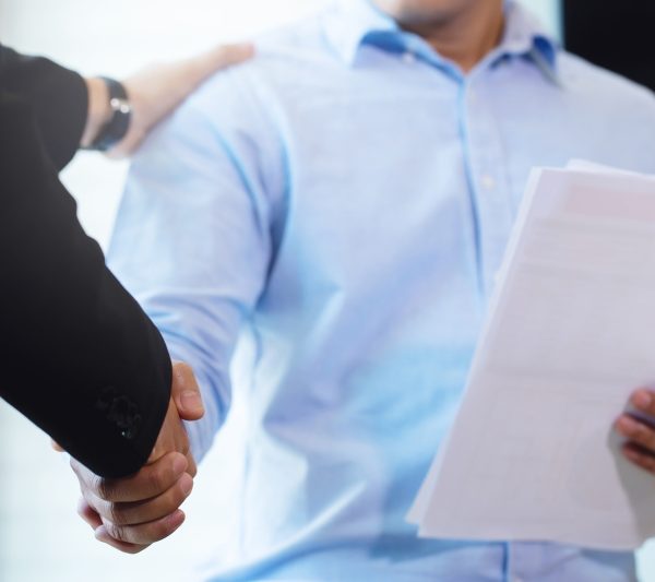 Business people shaking hands, finishing up a meeting.handshake of happy business people after contract agreement to become a partner,collaborative teamwork.