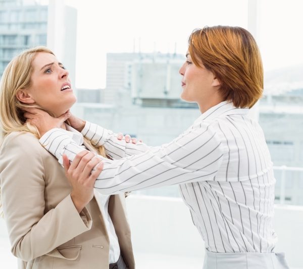 Side view of businesswomen having a violent fight in office